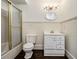 Bathroom with shower and tub, vanity, wainscotting and dark hardwood floors at 5809 Warren Farm Sw Rd, Powder Springs, GA 30127