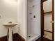 Bathroom featuring pedestal sink, walk-in shower and access to a walk-in closet at 5809 Warren Farm Sw Rd, Powder Springs, GA 30127