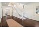 Bright entryway with hardwood floors, a white staircase, stained glass window and chandelier at 5809 Warren Farm Sw Rd, Powder Springs, GA 30127