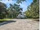 Charming two-story home with a metal roof, mature trees, and well-maintained grounds at 5809 Warren Farm Sw Rd, Powder Springs, GA 30127