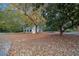 Exterior view of a white home with a pool on a tree covered lot at 5809 Warren Farm Sw Rd, Powder Springs, GA 30127
