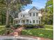 Attractive home with a manicured lawn, a brick walkway, and mature landscaping at 5809 Warren Farm Sw Rd, Powder Springs, GA 30127