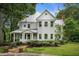 Beautiful two-story home with a covered porch, brick walkway, and professionally landscaped yard at 5809 Warren Farm Sw Rd, Powder Springs, GA 30127