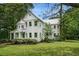 Elegant two-story home with a metal roof, brick chimney, and manicured landscaping at 5809 Warren Farm Sw Rd, Powder Springs, GA 30127