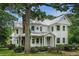 Charming two-story home featuring a metal roof, covered porch, and mature trees at 5809 Warren Farm Sw Rd, Powder Springs, GA 30127