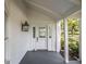 Inviting front porch with a beautiful glass-paneled front door and stylish black sconce lighting at 5809 Warren Farm Sw Rd, Powder Springs, GA 30127