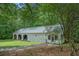 Large garage with a metal roof and multiple bays at 5809 Warren Farm Sw Rd, Powder Springs, GA 30127