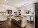 Bright kitchen featuring a center island with barstool seating and stainless steel appliances at 5809 Warren Farm Sw Rd, Powder Springs, GA 30127