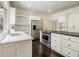Bright kitchen with granite countertops, stainless steel appliances, and ample cabinet space at 5809 Warren Farm Sw Rd, Powder Springs, GA 30127