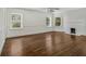 Living room features hardwood floors, natural light from the many windows, and a charming fireplace at 5809 Warren Farm Sw Rd, Powder Springs, GA 30127
