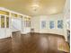 Spacious living room with hardwood floors, built-in shelving, large windows, and a fireplace at 5809 Warren Farm Sw Rd, Powder Springs, GA 30127