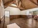 Grand living room featuring wooden beams, unique wood walls and hardwood floors at 5809 Warren Farm Sw Rd, Powder Springs, GA 30127