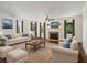 Inviting living room with a fireplace, hardwood floors, and large windows offering natural light at 5809 Warren Farm Sw Rd, Powder Springs, GA 30127