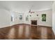 Open living room featuring a fireplace, hardwood floors, and large windows at 5809 Warren Farm Sw Rd, Powder Springs, GA 30127