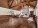 Grand living room featuring wooden beams, unique wood walls and hardwood floors, complete with stone fireplace at 5809 Warren Farm Sw Rd, Powder Springs, GA 30127