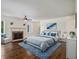Staged main bedroom with hardwood floors, a fireplace, and a seating area at 5809 Warren Farm Sw Rd, Powder Springs, GA 30127