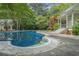 Inviting in-ground pool with a patio area and gazebo-style structure for outdoor enjoyment at 5809 Warren Farm Sw Rd, Powder Springs, GA 30127