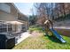 Expansive backyard featuring patio with dining set, playset, and retaining wall at 3952 Rhyne Way, Smyrna, GA 30082
