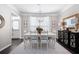 Elegant dining room with a modern chandelier, neutral walls, and large windows providing natural light at 3952 Rhyne Way, Smyrna, GA 30082