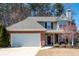 Charming two-story home featuring a brick facade, attached garage, and beautifully landscaped front yard at 3952 Rhyne Way, Smyrna, GA 30082