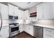 Bright kitchen features stainless steel appliances, granite countertops, subway tile backsplash, and white cabinets at 3952 Rhyne Way, Smyrna, GA 30082