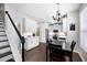 Modern kitchen with white cabinets, stainless steel appliances, and a center island, adjacent to a dining area at 3952 Rhyne Way, Smyrna, GA 30082