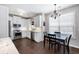 Bright kitchen features white cabinets, granite countertops, stainless steel appliances, and a breakfast nook with a modern chandelier at 3952 Rhyne Way, Smyrna, GA 30082
