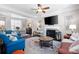Open-concept living room featuring a fireplace, ceiling fan, and stylish furnishings at 3952 Rhyne Way, Smyrna, GA 30082