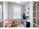 Play area with toys and furniture; with white-painted walls and natural light from window with blinds at 3952 Rhyne Way, Smyrna, GA 30082