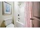 Bathroom featuring a shower-tub and pink shower curtain at 5825 Trailwood Ct, Suwanee, GA 30024