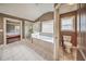 Bright bathroom features a large tub, glass-enclosed shower, and a separate toilet area at 5825 Trailwood Ct, Suwanee, GA 30024