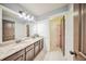 Stylish bathroom boasts double sinks, granite countertop, and modern fixtures at 5825 Trailwood Ct, Suwanee, GA 30024