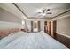 Bedroom featuring hardwood floors, a tray ceiling, and double doors at 5825 Trailwood Ct, Suwanee, GA 30024