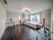 Bright bedroom with hardwood floors, desk, and comfortable bed at 5825 Trailwood Ct, Suwanee, GA 30024