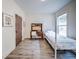 Bedroom with light walls, hard wood floors, a single bed and desk at 5825 Trailwood Ct, Suwanee, GA 30024