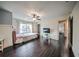 Bright bedroom with dark wood floors, window and stylish decor at 5825 Trailwood Ct, Suwanee, GA 30024