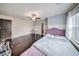 Bright bedroom with hardwood floors and a view through the window at 5825 Trailwood Ct, Suwanee, GA 30024