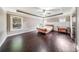 A bedroom featuring hardwood floors, a tray ceiling, and built-in wainscoting at 5825 Trailwood Ct, Suwanee, GA 30024