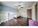 Cozy bedroom features hardwood floors, built-in shelving, and ceiling fan at 5825 Trailwood Ct, Suwanee, GA 30024