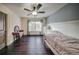 Inviting bedroom featuring hardwood floors, built-in shelves, and lots of natural light at 5825 Trailwood Ct, Suwanee, GA 30024