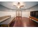 Entertainment bonus room with hardwood floors, large windows, TV, and comfortable seating at 5825 Trailwood Ct, Suwanee, GA 30024