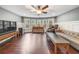Spacious bonus room with hardwood floors, neutral walls, large windows, and modern furniture at 5825 Trailwood Ct, Suwanee, GA 30024