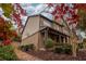 Charming brick home with covered front porch and landscaped yard with colorful fall foliage at 5825 Trailwood Ct, Suwanee, GA 30024