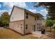 Back exterior of home with siding, brick foundation, and small patio perfect for entertaining at 5825 Trailwood Ct, Suwanee, GA 30024