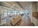 An open concept great room boasts hardwood floors, a ceiling fan, and plenty of natural light at 5825 Trailwood Ct, Suwanee, GA 30024