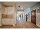A long hallway provides built-in cabinetry, natural lighting, and hardwood floors at 5825 Trailwood Ct, Suwanee, GA 30024