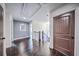 Hallway with hardwood floors and dark wood doors at 5825 Trailwood Ct, Suwanee, GA 30024