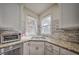 Close-up of the modern kitchen's stylish granite countertops and backsplash, and stainless steel appliances at 5825 Trailwood Ct, Suwanee, GA 30024