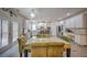 Elegant kitchen and dining area with modern appliances, white cabinets, granite countertops, and glass-top dining table at 5825 Trailwood Ct, Suwanee, GA 30024