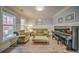 A bright living room offers light hardwood floors, large windows, and elegant furnishings at 5825 Trailwood Ct, Suwanee, GA 30024